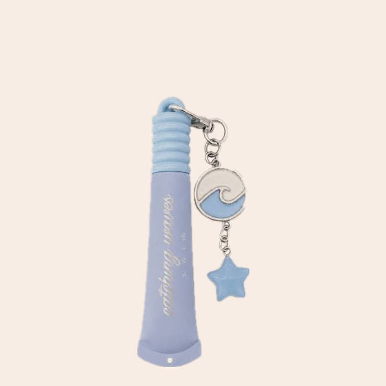 A periwinkle lip gloss on a keyring, with an enamel wave charm and a blue star